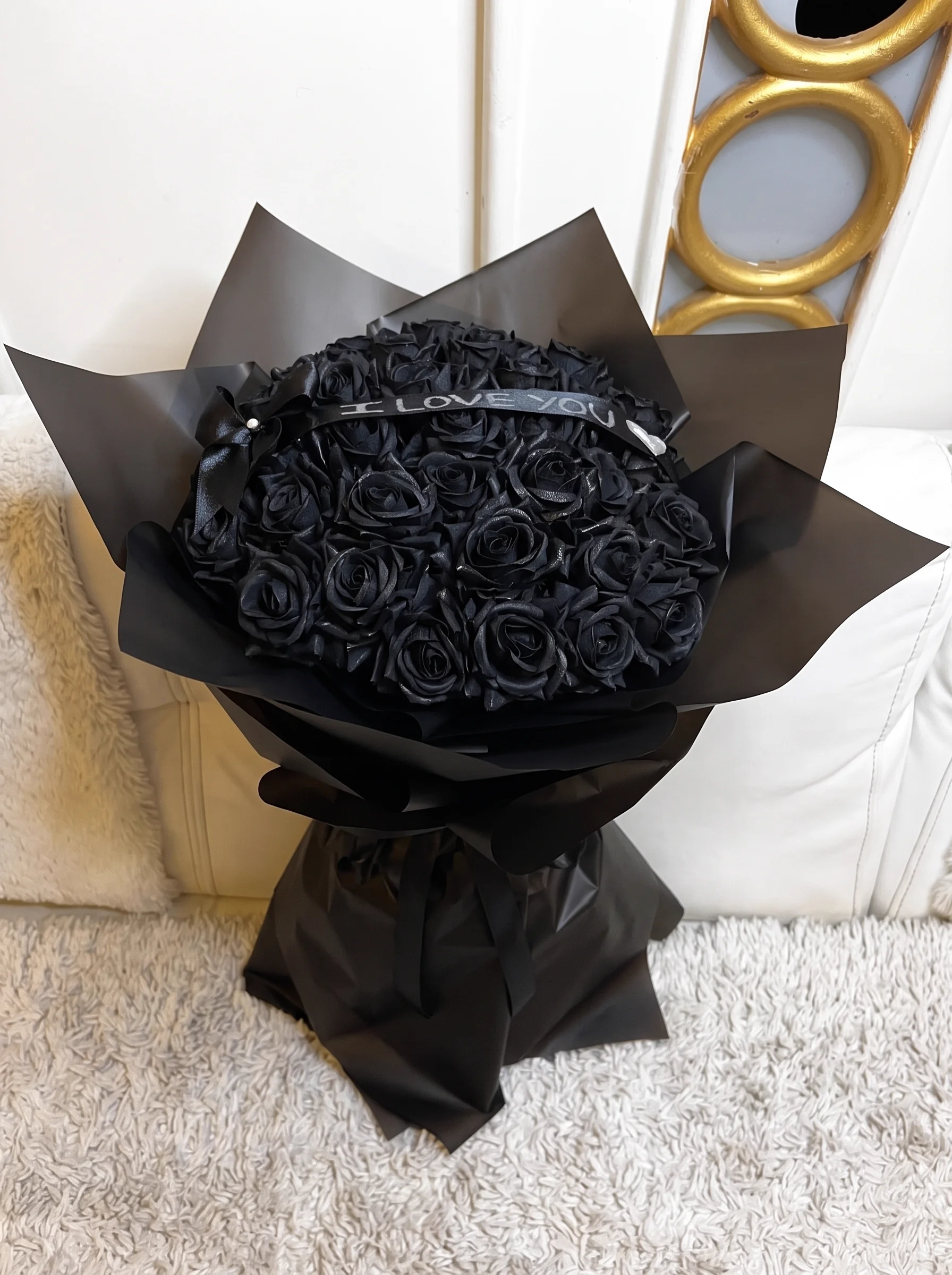 Angelic white wrap bouquet decorated with feather wings and matching silk ribbons